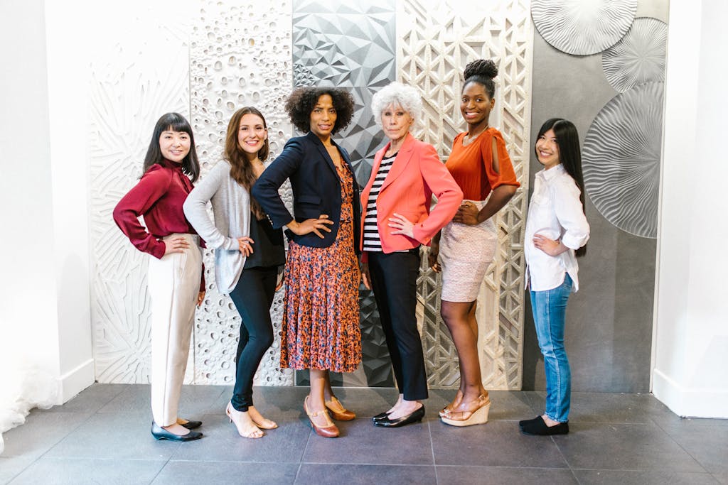 Group of confident women leaders posing in a stylish, modern office environment, showcasing empowerment and diversity.